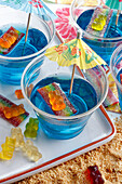 Blue jelly with mixed fruit gums and umbrellas