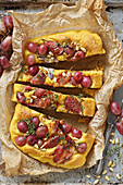 Pumpkin focaccia with bacon, figs and grapes