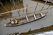 Benin, lakeside city of Ganvié, woman on boat