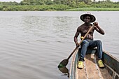 Ivory Coast, Grand Bassam, dugout driver on the lagoon