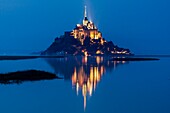 France, Manche, Mont Saint Michel Bay listed as World Heritage by UNESCO, Abbey of Mont Saint Michel and River Couesnon at dusk