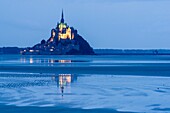 France, Manche, Vains, Mont Saint Michel Bay listed as World Heritage by UNESCO, Abbey of Mont Saint Michel, at dusk