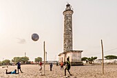 Ivory Coast, Grand Bassam, kids playing football on the beach