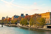 France, Paris, area listed as World Heritage by UNESCO, the banks of Seine river autumn, the Louvre Museum and the Passerelle des Arts