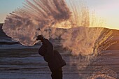 China, Inner Mongolia, Hebei Province, Zhangjiakou, Bashang Grassland, Colline landscape, men sending water or milk in the cold air, ritual scene