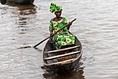 Benin, lakeside city of Ganvié, woman on boat