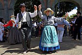 Spain, Canary Islands, Tenerife Island, couple in traditional Canarian costumes dancing during a romería, a village festival