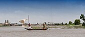 Benin, lakeside city of Ganvié, dugout with handmade sail