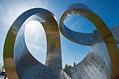 France, Switzerland, Cern, door open, the sculpture Peregrination to infinity by the Canadian artist Gayle Hermick represents a ribbon 37 m long and 11 m high is installed in front of the museum of the globe