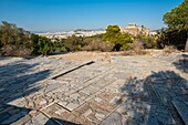 Greece, Athens, paved path leading to the Hill of the Muses or Philopappos Hill, the Acropolis of Athens (UNESCO World Heritage Site) in the background