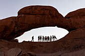 Namibia, Erongo province, Spitzkoppe, tourists under the arch