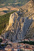 France, Alpes-de-Haute-Provence, Sisteron, view of the roofs of the old town and the vertical strata of the rock of Baume