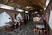 Spain, Canary Islands, Palma island, couple seated at the Tamanca bodega restaurant, installed in a stone cellar