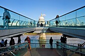 United Kingdom, London, the Millennium Bridge by architect Norman Foster on the Thames river and St. Paul's Cathedral in the background