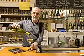 France, Indre et Loire,Montlouis sur Loire, le Conciliabule, associative bar, cafe bookstore,waiter at the bar