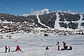 France, Savoy, Beaufortain massif, ski lessons on the slopes of Bisanne and view of the resort of Col des Saisies and Mont Blanc