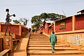 Benin, Porto Novo, man climbing typical stairs of Adjina district