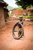 Benin, Nothern distict, Atacora mountains area, Tanguiéta, child playing with a tire