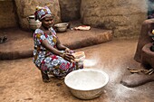 Benin, Nosthern distict, Atacora department, Koussoukoingou area, woman Otammari ethny sifting garri flour (cassava)