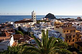 Spain, Canary Islands, Tenerife Island, Garachico, bird's-eye view of the tiled roofs of colonial houses and the Church of Santa Ana, on the ocean floor