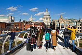 United Kingdom, London, on the Millennium Bridge by architect Norman Foster on the Thames river and St. Paul's Cathedral in the background