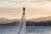 Spain, Canary Islands, Fuerteventura Island, Caleta de Fuste, man using water powered jet pack