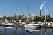 Canada, Province of Quebec, Mauricie Region, Trois-Rivières, St Quentin Island Park Marina and Bottom chimneys of Kruger Wayagamack Inc.