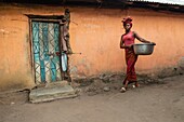 Benin, Natitingou district, woman back from washing clothes