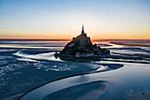 France, Manche, The Mont Saint Michel at sunrise, from a drone machine