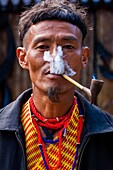 India, Nagaland, Kisima, naga Hornbill festival, man with a pipe