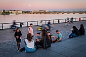 France, Gironde, Bordeaux, area listed as World Heritage by UNESCO, Bordeaux youth on Quai Richelieu, at the bottom the Pont de Pierre above the Garonne