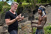 Papua New Guinea, Gazelle peninsula, New Britain island, East New Britain province, Rabaul, Kokopo, Tavurvur volcano, german journalist and traveller Jenke von Wilmsdorff looking at eggs of megapode bird also known as incubator birds or mound-builders (Megapodiidae)