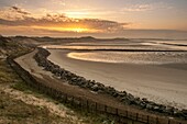 France, Pas-de-Calais (62), Côte d'Opale, Berck-sur-mer, North Authie Bay, at rising sun on an Autumn morning, view of the dikes protecting the coastline from immersion