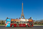 France, paris, district of the Eiffel tower listed as World Heritage by UNESCO, touristic bus in front of the Eiffel tower