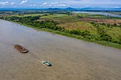 Papua New Guinea, East Sepik Province, Sepik River Region, Kanganamun Village area, timber barge boat (Aerial View)