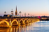 France, Gironde, Bordeaux, area listed as World Heritage by UNESCO, the Pont de Pierre over the Garonne, at the bottom the spire and the Saint-Michel Basilica in Bordeaux