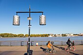 France, Gironde, Bordeaux, area listed as World Heritage by UNESCO, cyclists on the quai du Maréchal Lyautey