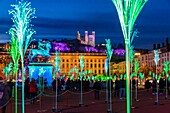 France, Rhone, Lyon, historical site listed as World Heritage by UNESCO, equestrian statue of Louis XIV on place Bellecour (Bellecour Square) and Notre Dame de Fourviere Basilica, show Prairie ephemere of TILT and Porte par le Vent