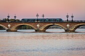 France, Gironde, Bordeaux, area classified as World Heritage by UNESCO, tram of the TBM network on the Pont de Pierre over the Garonne, brick and stone arch bridge inaugurated in 1822