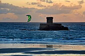 United Kingdom, Channel Islands, Jersey, Saint Brelade, St Ouen's Bay, kite surfer in front of La Rocco Tower