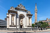 France, Nord, Lille, Porte de Paris with in the background the belfry of town hall listed as World Heritage by UNESCO