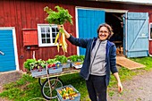 Sweden, County of Vastra Gotaland, Hokerum, Ulricehamn hamlet, Rochat family, market preparation, Sonia and the bouquet of the most beautiful carrots