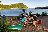 Canada, Province of Quebec, Mauricie Region, Hydravion Aventure, Saint-Maurice Wildlife Sanctuary north of Mauricie National Park, family camping for the night on a sandy beach on Lac Soucis with the pilot , dinner, aperitif MODEL RELEASE OK