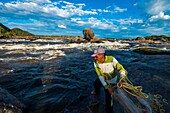 Colombia, Llanos, Tuparro National Park, Maipure raudales , or whitewaters, net fisherman