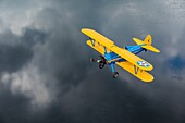 Canada, Province of Quebec, Mauricie region,Hydravion Aventure, Flight of a Boeing Stearman 1943 over the Saint-Maurice River under a stormy sky