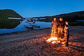 Canada, Province of Quebec, Mauricie Region, Saint-Maurice Wildlife Sanctuary north of La Mauricie National Park, Hydravion Aventure, camp on a sandy beach at Lac Soucis, cooking with family marshmallows on fire camp MODEL RELEASE OK