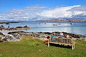 United Kingdom, Scotland, Highland, Inner Hebrides, rocks and sandy beach on Iona Island facing the Ross of Mull