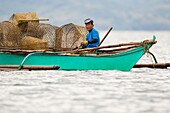 Philippines, Palawan, Malampaya Sound Protected Landscape and Seascape, fisherman dropping crab traps