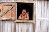 Madagascar, Diana region, village of Marosely, a woman at the window of her hut