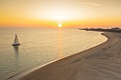 France, Somme, Baie de Somme, Le Hourdel, as the sun just rises, the first boats take the channel to leave the bay and pass close to the seals on the sandbanks and the blockhouse